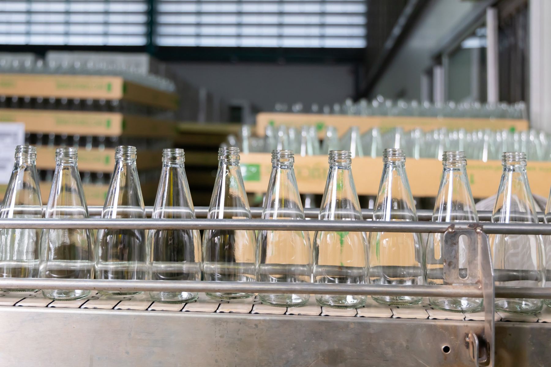 Empty glass bottles on a conveyor
