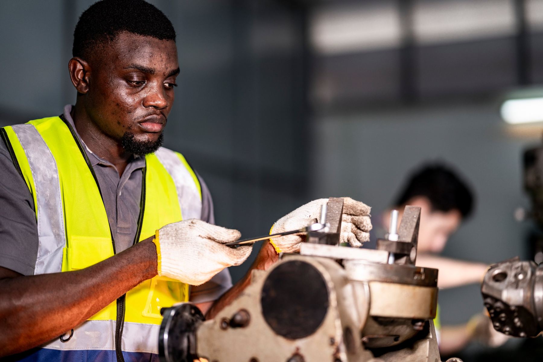 Fitter adjusting a machine assembly with a spanner