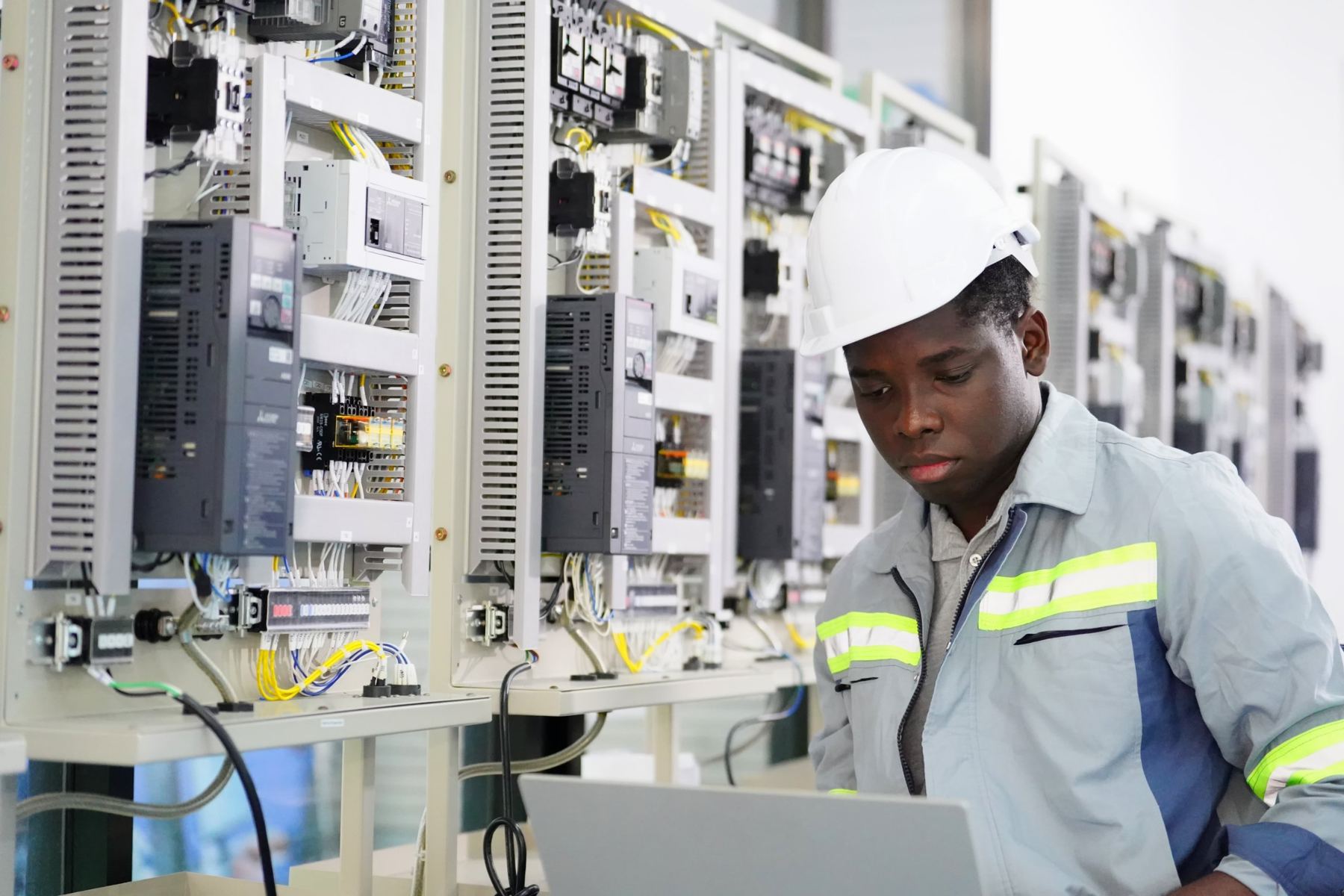 Technician beside control panels with variable speed drives