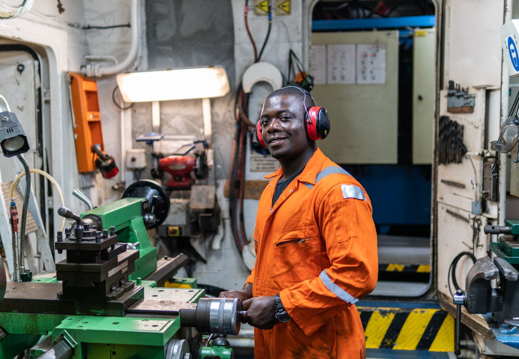 Technician in overalls working in a workshop